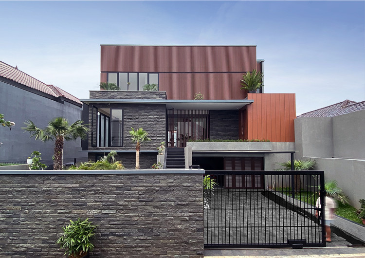 a house with a gate and palm trees