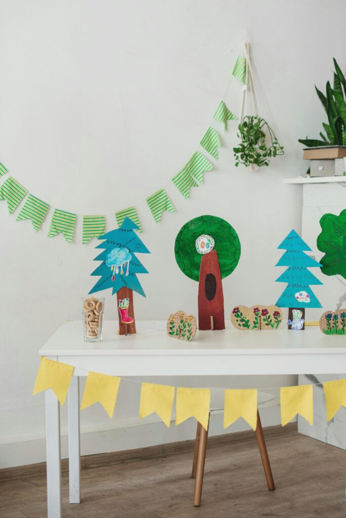 a table with paper cutouts and a garland